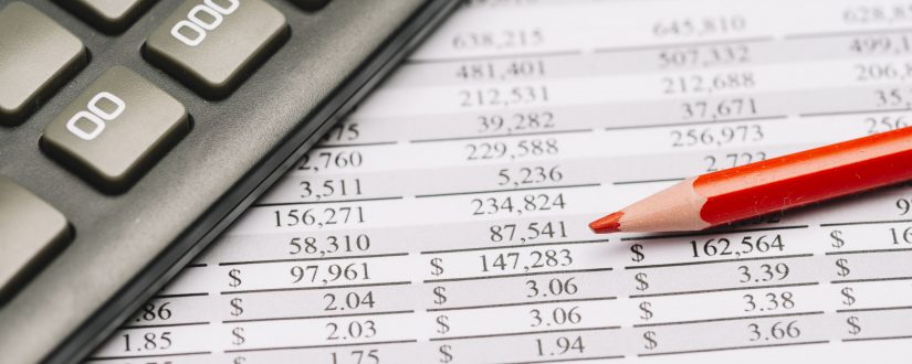 close-up-of-red-colored-pencil-with-calculator-over-the-financial-report